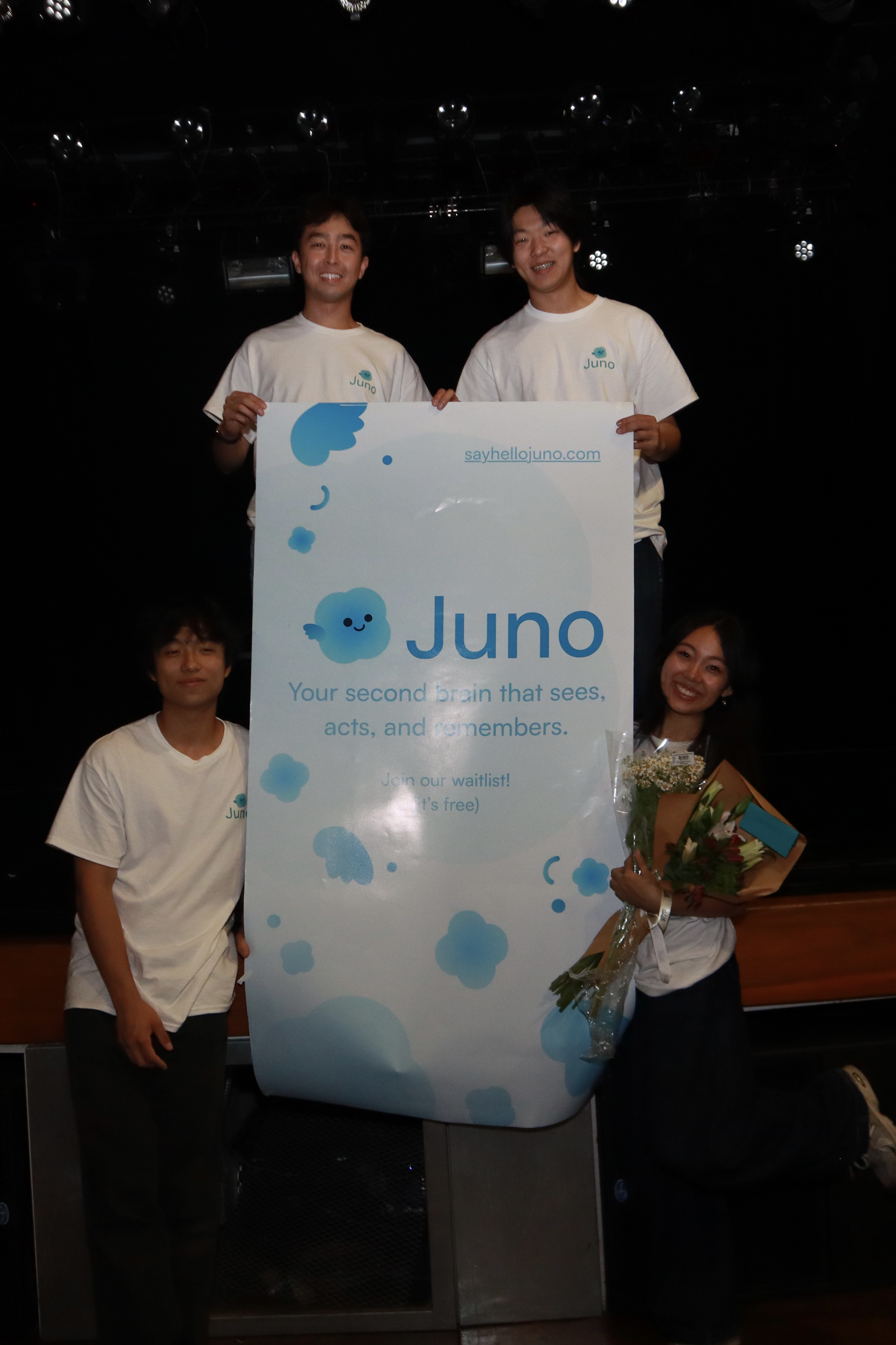 The Juno team with our demo night poster and flowers