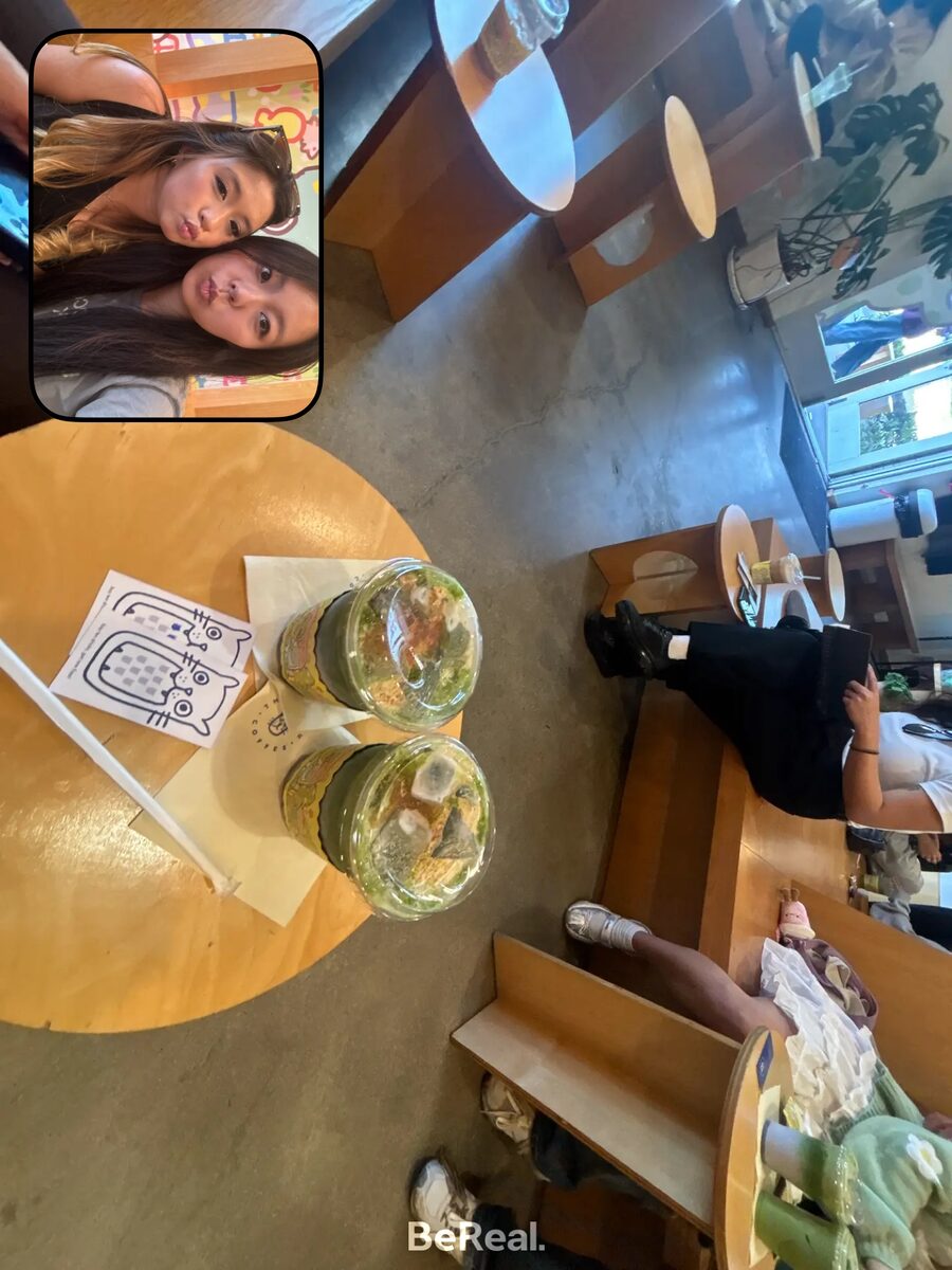 Two iced matcha drinks on a cafe table