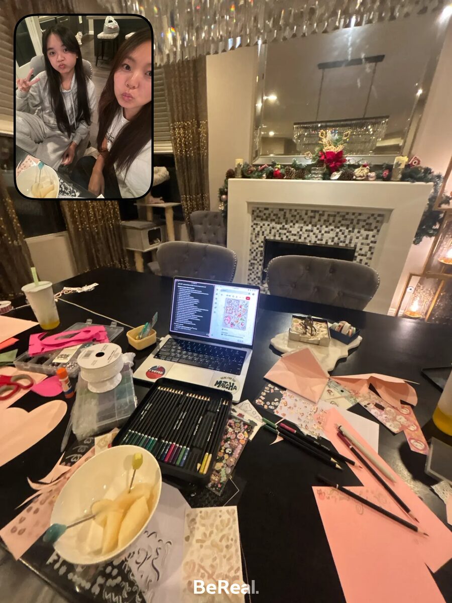 A table covered in card-making supplies by a decorated fireplace